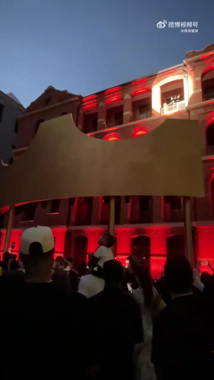 詹姆斯中国行站在四层高的建筑拱门中，向上海球迷问候致意！