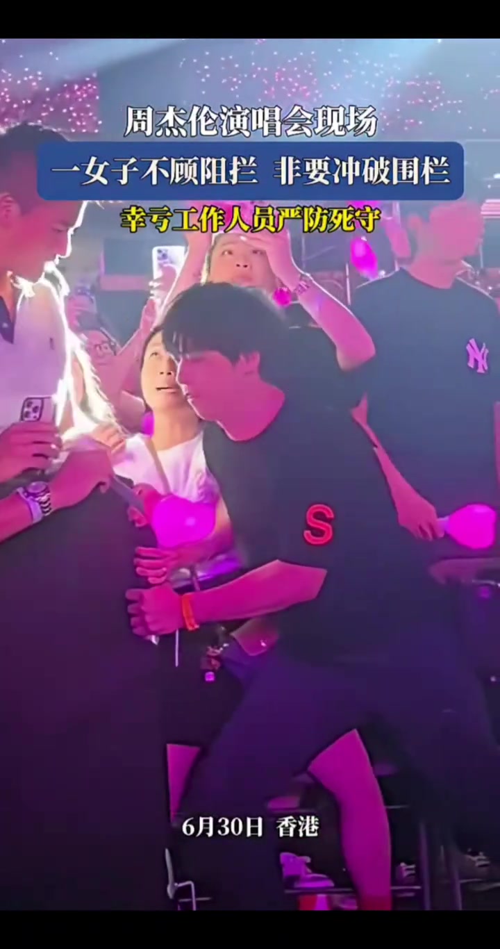 周杰伦演唱会现场，一女子不顾阻拦，非要冲破围栏