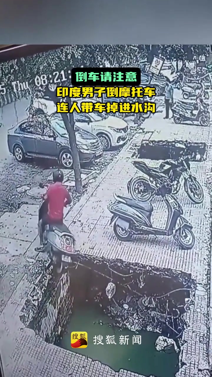 印度男子倒摩托车连人带车掉进水沟