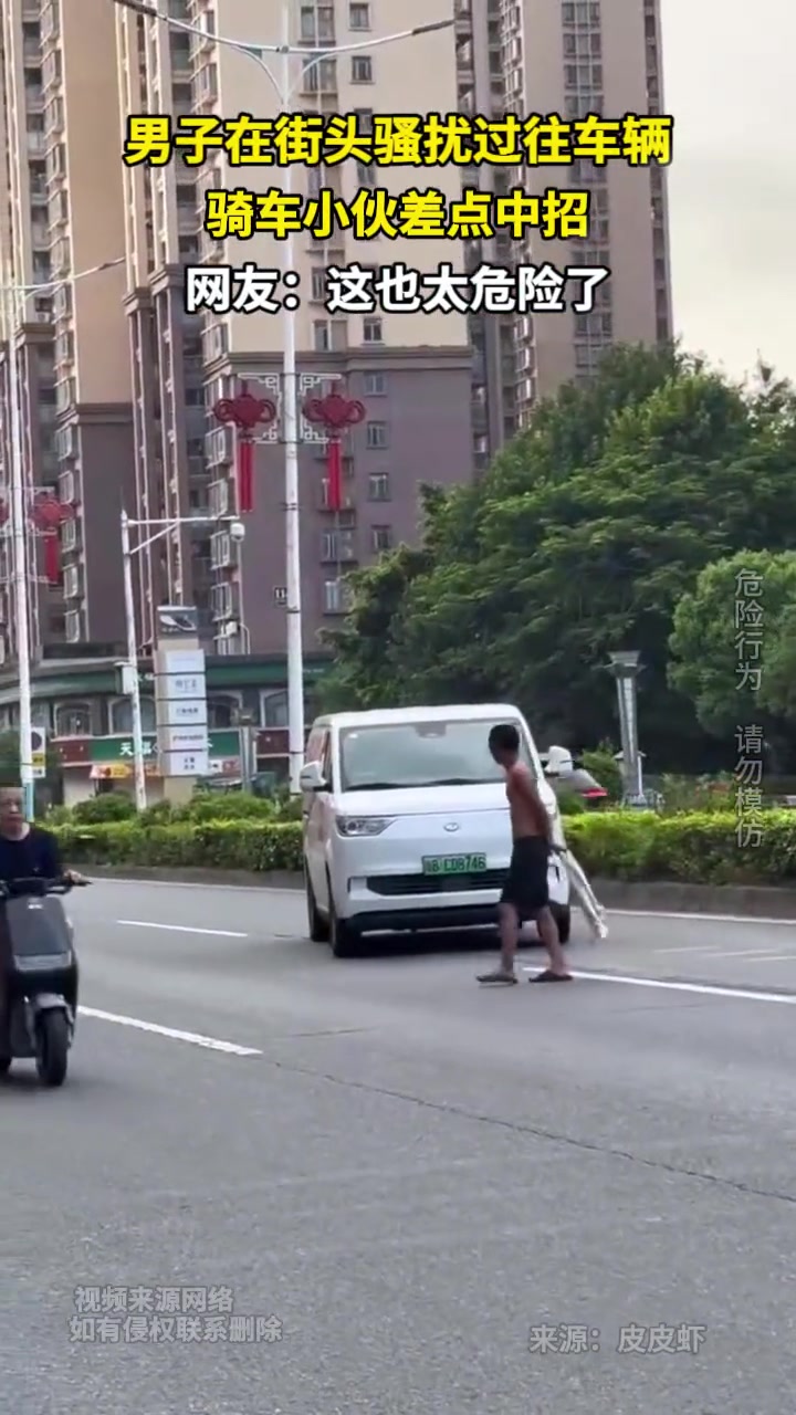 男子在街头骚扰过往车辆，骑车小伙差点中招！！